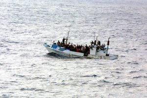 a boat overloaded with people - refugees