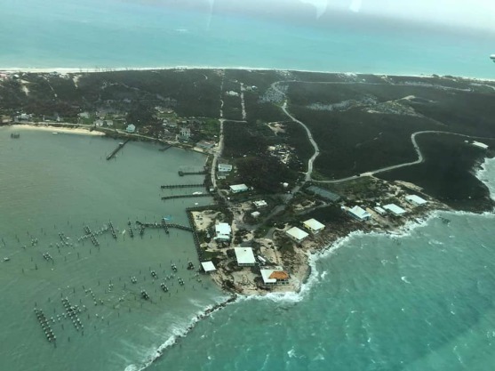 aerial photo of sunken pontoons and flattened buildings after the hurricane has passed